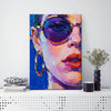 wall art painting on the table depicts woman wearing round sunglasses and large hoop earrings