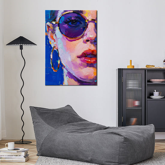 wall art painting in the living room depicts woman wearing round sunglasses and large hoop earrings