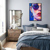 black frame wall art painting depicts woman wearing round sunglasses and large hoop earrings