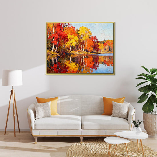 gold frame wall art painting of an autumn lakeside hangs on a simple and bright interior wall