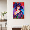 gold frame wall art painting of a lady's portrait hanging on a white wall in a room