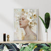 white frame wall art canvas painting depicts a woman wearing white flowers