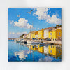 wall art canvas painting depicts a bright harbor scene in a seaside town