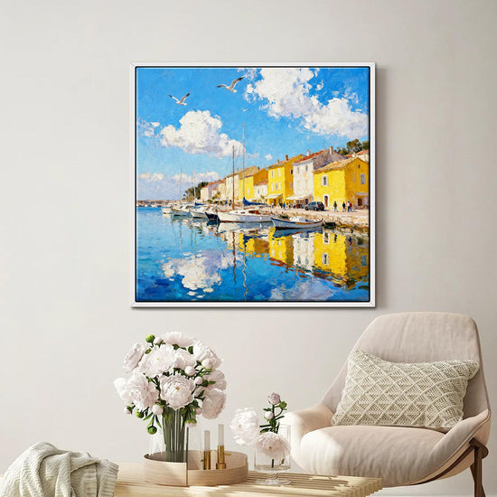 white frame wall art canvas painting depicts a bright harbor scene in a seaside town