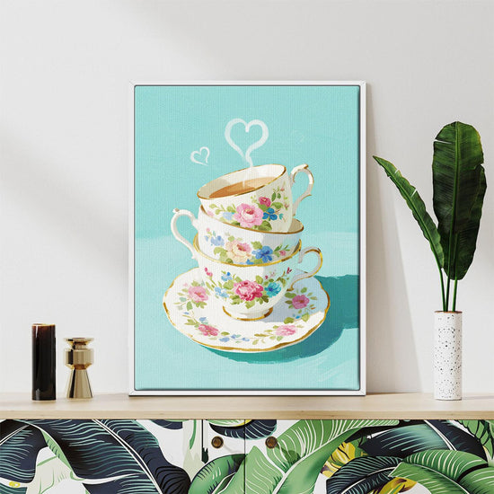 white frame wall art canvas painting depicts stacked floral teacups
