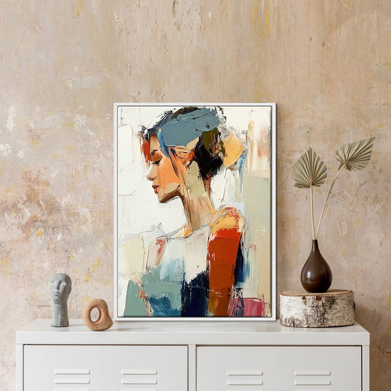 white frame wall art women painting on the table