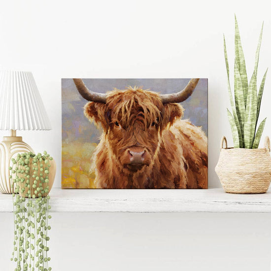 wall art canvas on the table depicts highland cattle