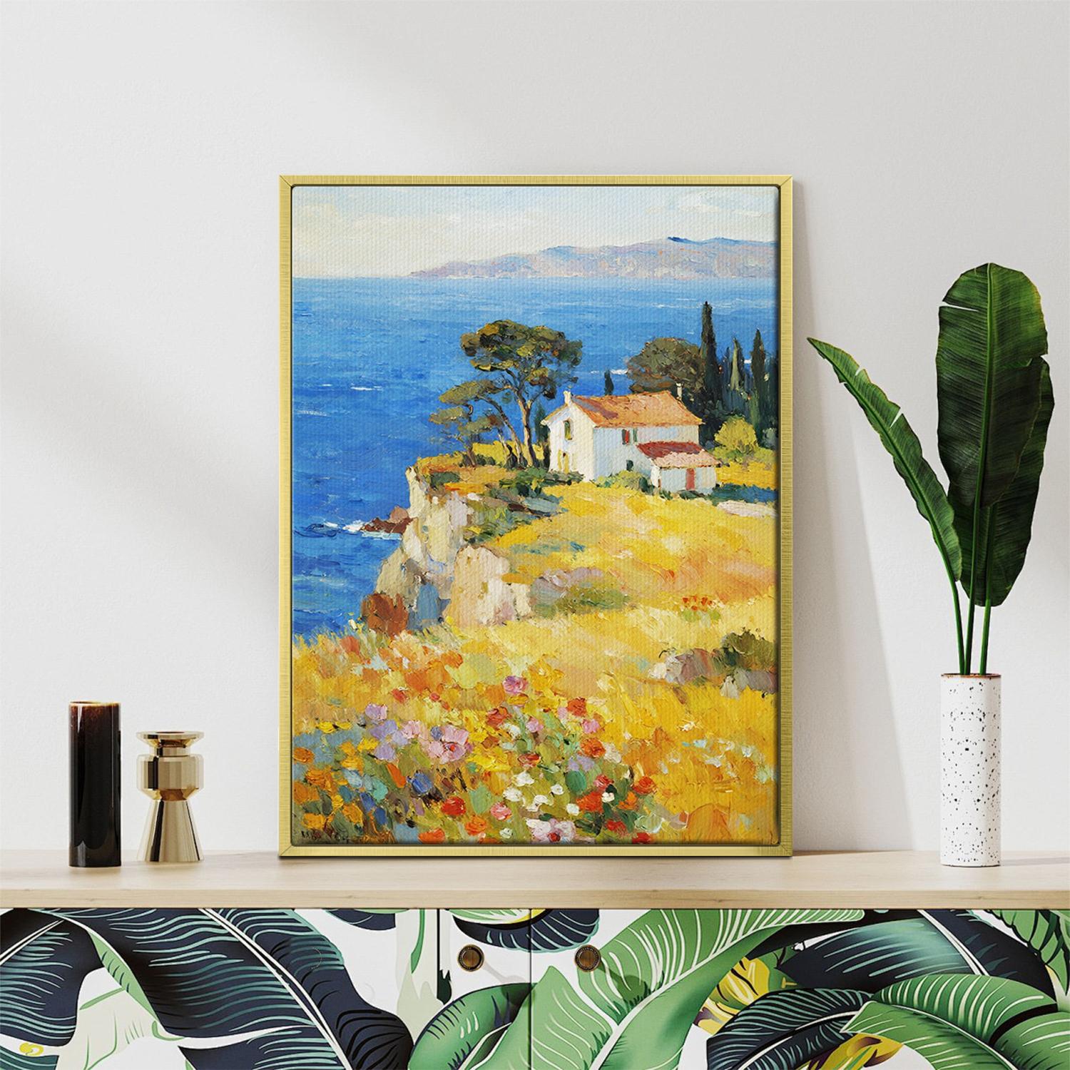 gold frame wall art painting depicting a cliffside cottage by the sea