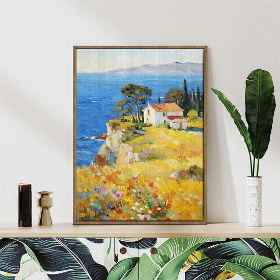 light oak color frame wall art painting depicting a cliffside cottage by the sea