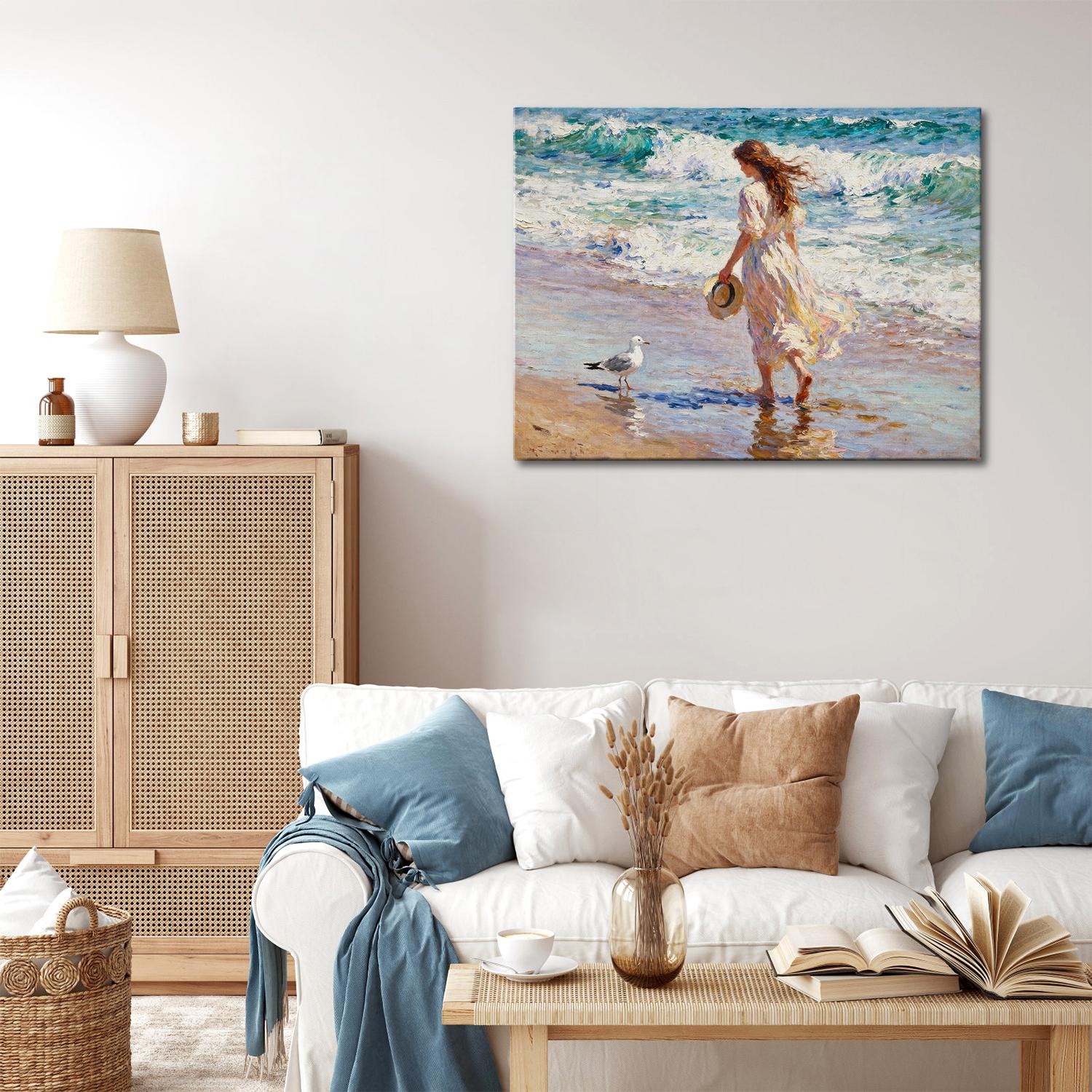 wall art painting in the living room depicts a woman in a flowing long dress walking on the beach, accompanied by seagulls.